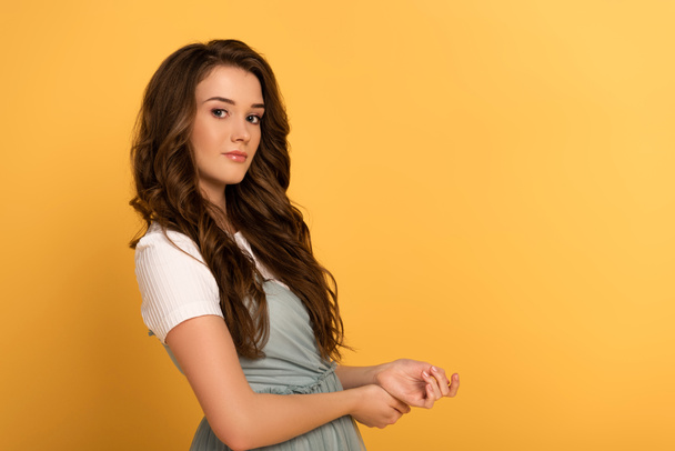 beautiful young spring woman with long hair on yellow - Foto, Imagem