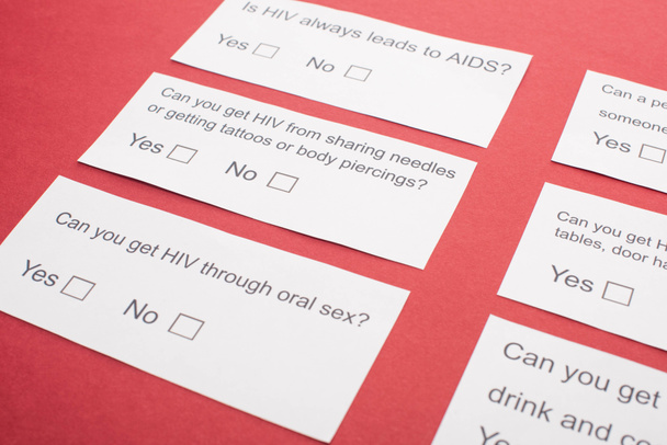 paper cards with HIV questionnaire on red background - Zdjęcie, obraz