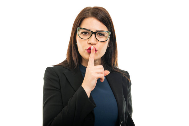 Portrait of young business girl making silence gesture isolated on white background - Фото, зображення
