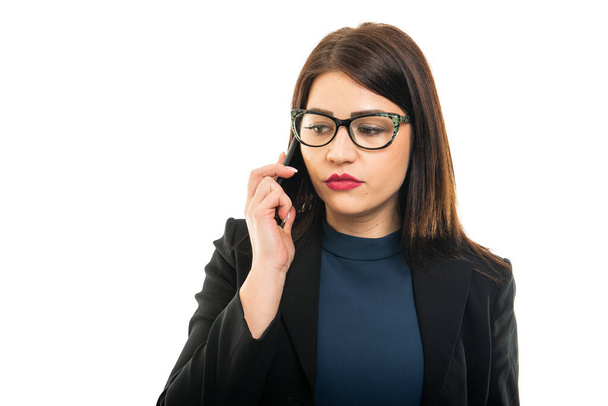 Portrait of business girl wearing glasses talking at cell phone isolated on white background with copy space advertising area - Φωτογραφία, εικόνα