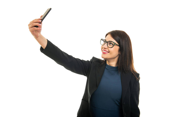 Portrait of business girl wearing glasses taking selfie isolated on white background with copy space advertising - Fotoğraf, Görsel