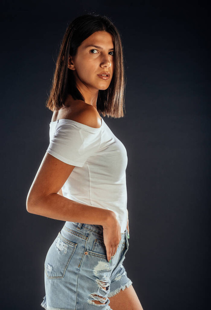 Vonzó fiatal női modell pózol fekete háttér - Fotó, kép