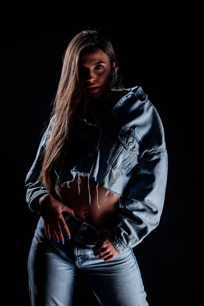 Studio body shot of a fashion female model posing in modern clothing - Fotografie, Obrázek