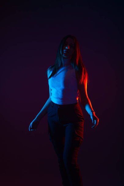 Kék és piros fénykép egy fekete hátterű, nagy kontrasztú női modellről - Fotó, kép