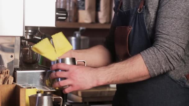 Italian coffee machine. Professional barista making cappuccino. Barista pouring whipped milk in a metal cup. - Кадри, відео