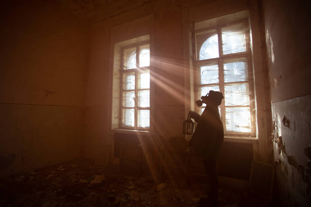 Post apocalyptic survivor in gas mask in a ruined building. Hope after environmental disaster concept. - Photo, Image