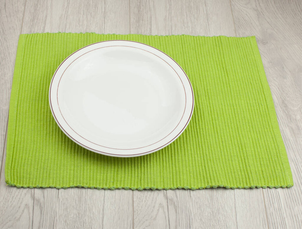 Top view of empty white food plate on a wood background. - Photo, Image