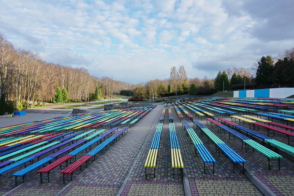 Singing field in Ternopil. Brightly painted benches for recreation in the park. Spring evening in the parks. Bright Ternopil paints.  - Photo, Image