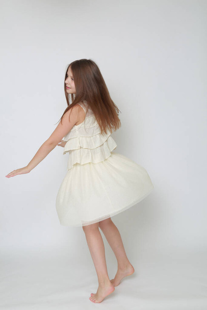 Studio image of happy emotional caucasian little girl moving and dancing - Foto, Imagem