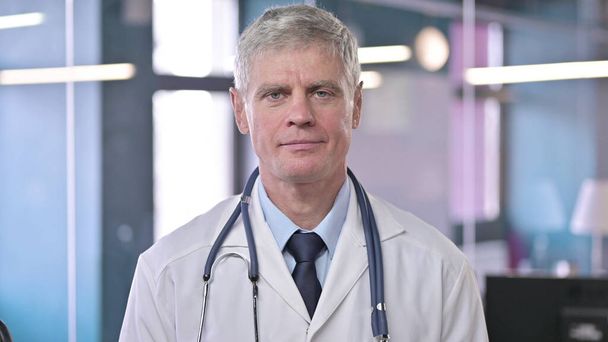 Portrait of Serious Middle Aged Doctor looking at Camera - Φωτογραφία, εικόνα