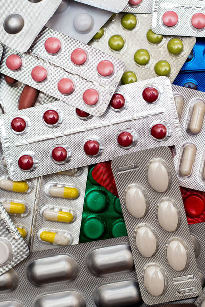 A pile of multi-colored pills lie one on on - Photo, Image