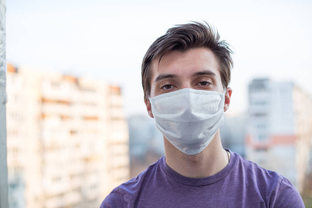 A young guy of European looking wears a medecine mask - Fotoğraf, Görsel