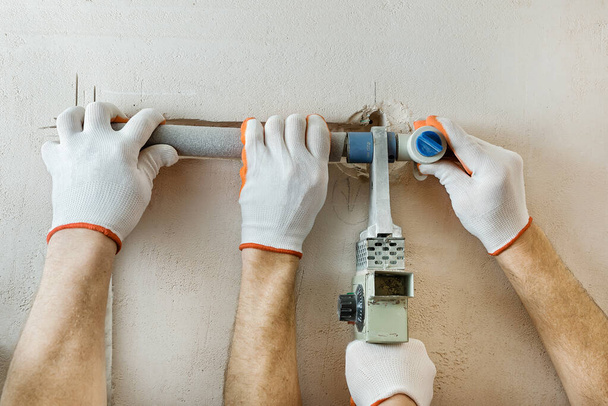 Installation of water pipes in the wall for the built-in shower. Soldering of parts of plumbing. - 写真・画像