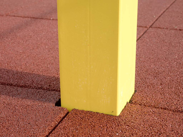 Yellow iron bar on workout playground. The beam holds horizontal acrobatic pole. - Photo, Image