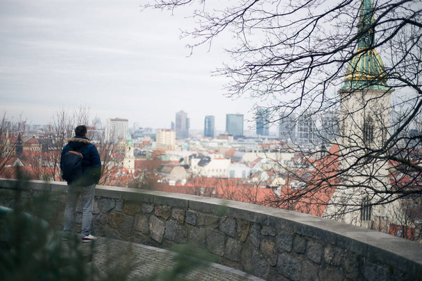 Guy looking at the center of the old town of Bratislava - Photo, image