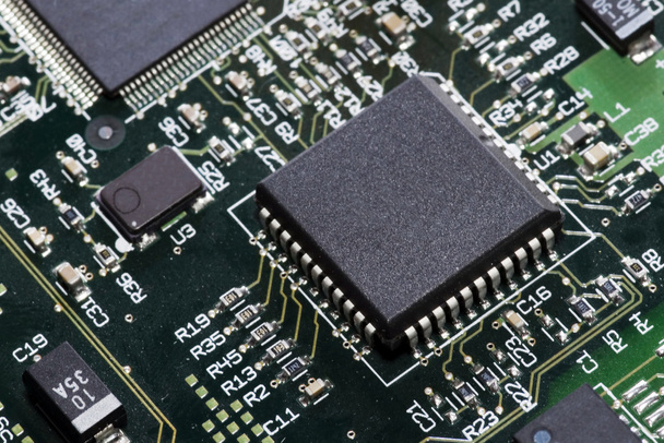 Close-up on a microchip on a scheme background - Foto, Bild