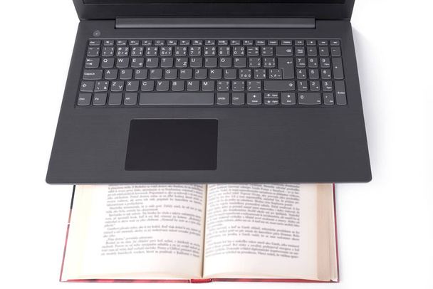 Modern slim lightweight laptop on a book - Foto, imagen