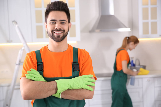 Professional janitor in uniform indoors. Cleaning service - Foto, imagen