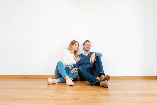 Couple dreaming about their future in the new apartment - Foto, afbeelding