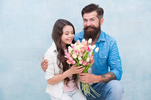 Birthday celebration. International womens day. Flower shop. Family tradition. She worth all treasures. Tender tulips for daughter. Man tulips bouquet. Father giving tulips girl. Dad with flowers - Foto, afbeelding