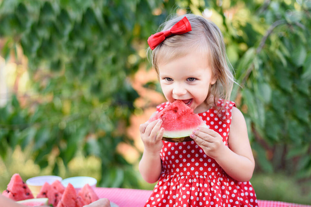 Χαριτωμένο παιδί τρώει ώριμο ζουμερό νερόμελο το καλοκαίρι. Παιδί, μωρό, υγιεινό σνακ για παιδιά. - Φωτογραφία, εικόνα