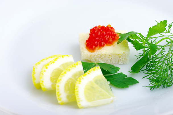 Sandwiches with red caviar and greens on a white plate - Photo, Image
