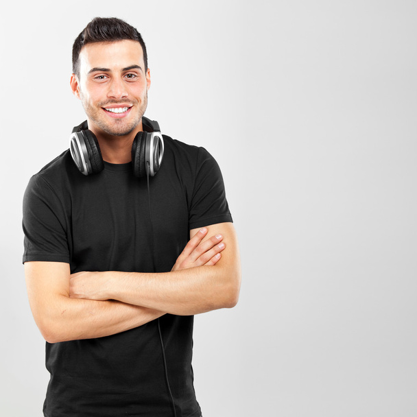 Young man wearing earphones - Fotografie, Obrázek
