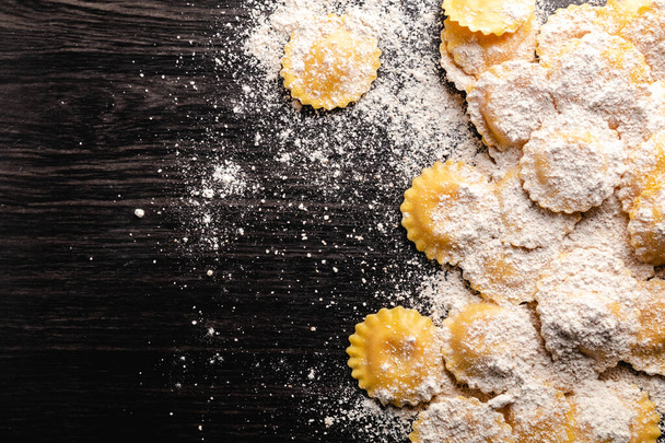 Cooking italian ravioli on wooden table. Top View with Copy Space. - 写真・画像