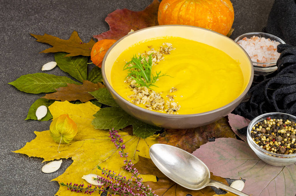 Горячий тыквенный суп на фоне сушеных осенних листьев. Студия фото
 - Фото, изображение