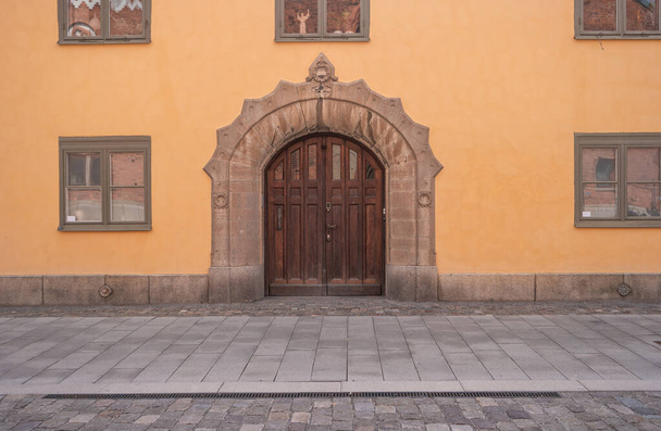 Facade of a building with a massive wooden door in Vasteras, Sweden. - Photo, image