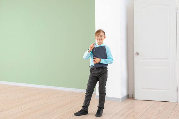 Little real estate agent with key indoors - Photo, Image