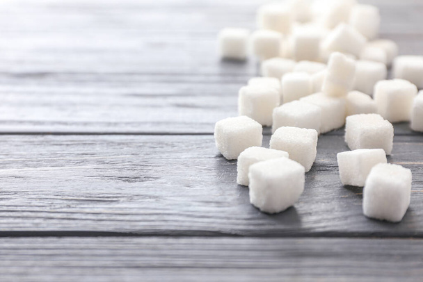 Cubes of sweet sugar on wooden background - Foto, Bild