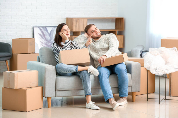 Young couple in their new flat on moving day - Photo, Image