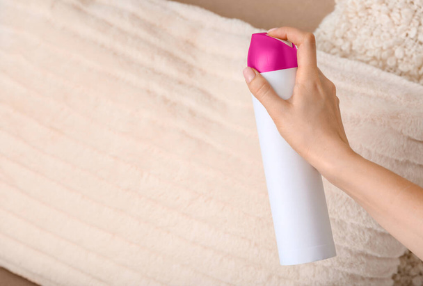 Woman spraying air freshener in room - Photo, Image
