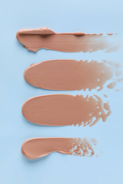 Samples of cream on color background - Foto, imagen