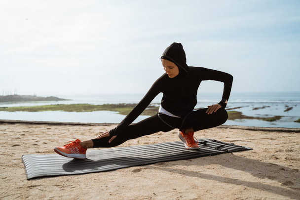 woman with muslim sport wear stretching - 写真・画像