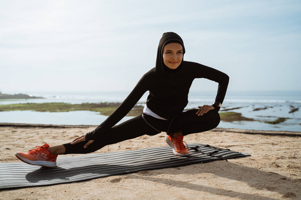 woman with muslim sport wear stretching - Foto, Imagen