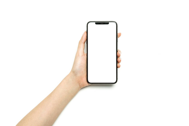 Femme main tenir un smartphone isolé sur blanc
. - Photo, image