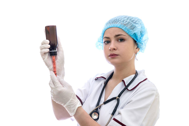 Doctor with bottle and syringe isolated on white - Фото, изображение