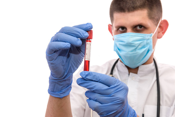 young doctor in uniform hold a blood sample. - Zdjęcie, obraz