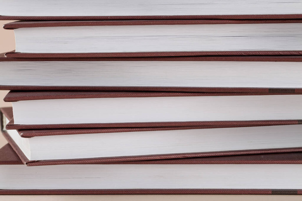 Close view of stack books on brown background. back to school - Foto, imagen
