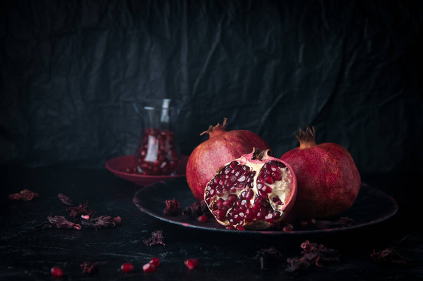 still life fruit pomegranates on a dark stone background - Photo, Image