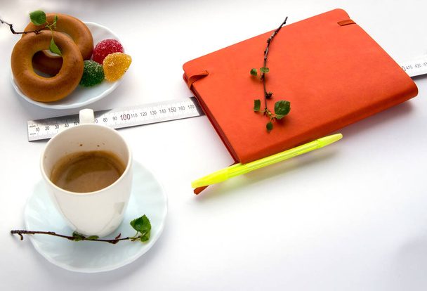  Coffee, plate, bagels, marmalade, sprig with green leaves, notebook, linear on a white background - Photo, Image