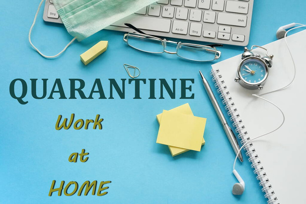 Coronavirus Covid -19 quarantine concept. Stay at home, work at home. Office desk top view on blue background. - Фото, зображення