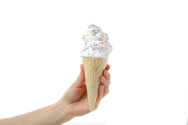 Female hand holds ice cream, isolated on white background - Fotó, kép