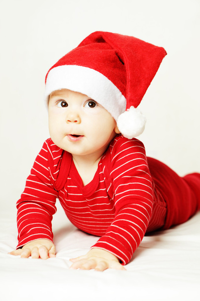 Surprised baby in red Santa hat - Photo, image