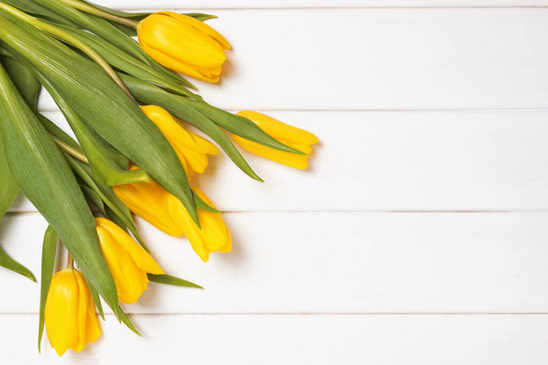 Bouquet of fresh bright spring tulips on white wooden background with copy space. - 写真・画像