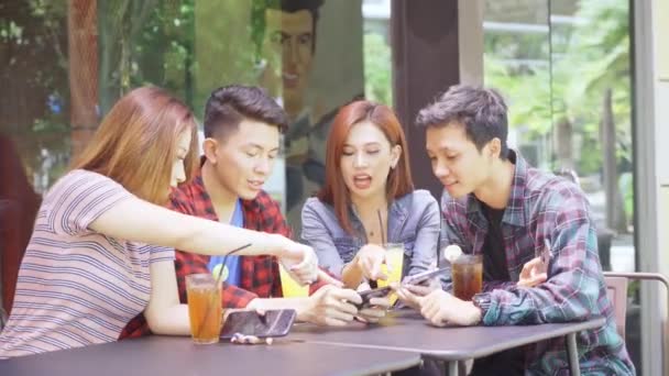 Asian young people using mobile phone in cafe - Materiaali, video