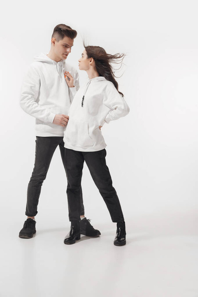 Trendy fashionable couple isolated on white studio background - Zdjęcie, obraz