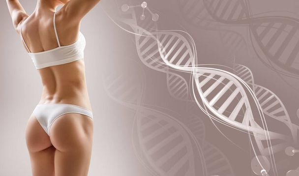 Sporty female body near DNA stems. Over beige background. - Photo, Image